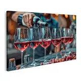 islandburner Bild auf Leinwand Eine Person füllt eine Reihe Weingläser mit edlem Rotwein auf dem Wandbild Weinkeller Weinhandel Wandbilder Bilder